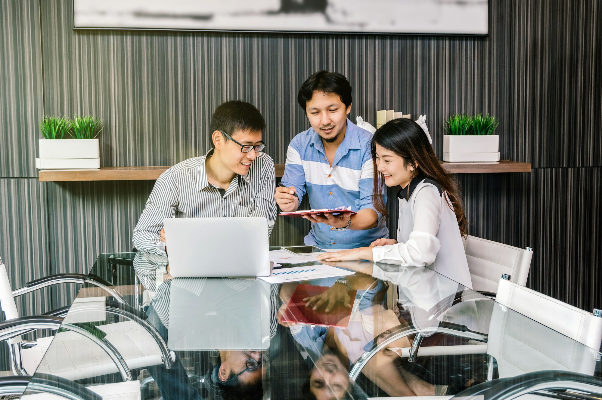 Group Of Asian Business people with casual suit meeting with relax action in the modern meeting