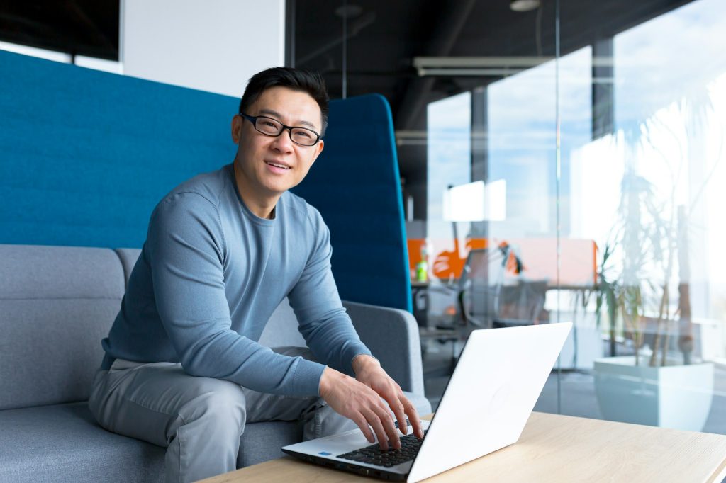 Portrait of male teacher, Asian working from training center office