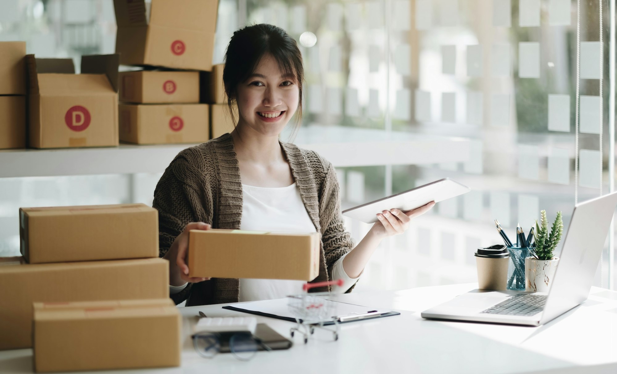 Startup small business entrepreneur SME, asian woman packing cloth in box. Portrait young Asian